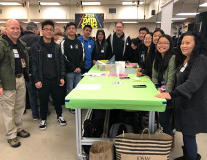 Students gather with teachers and mentors at a team event.